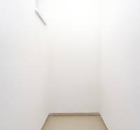 A small room with tiles in a 3-room apartment has two narrow windows.