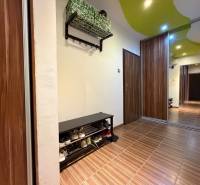 Entrance hallway in a 3-room apartment with a shoe cabinet and a mirrored wardrobe, floor with wood decor.