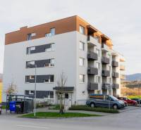 An apartment building on Liptovská Street in Trenčín, surrounded by greenery and a parking lot.