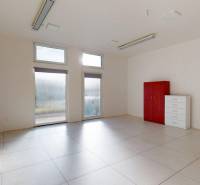 Spacious commercial spaces with white tiles, equipped with furniture and windows.