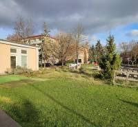 Commercial premises on Školská Street in Holíč surrounded by greenery and trees.
