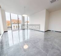 Spacious offices with large windows and ceramic tile flooring.