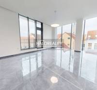 A spacious office with large windows and a shiny stone floor in Rimavská Sobota.