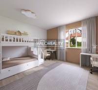Children's room with a bunk bed, desk, and floor with wooden decor in a family house.