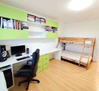 Children's room with a bunk bed, desk, and shelves in a 3-room apartment.