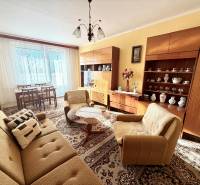 Living room in a 3-room apartment with classic furniture and large windows.