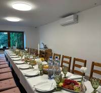 Interior of commercial premises with a long set table and chairs for a celebration.
