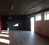 A dark room with red and black walls, a floor with a wooden decor.