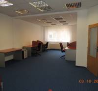 Offices with carpeted floors, desks, and swivel chairs.