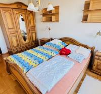 A bedroom with antique furniture and a wooden decor floor in a 4-room apartment.