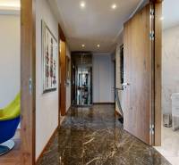 Interior of a 3-room apartment with a glossy floor and a cozy armchair in bright colors.