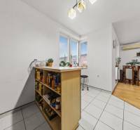 Kitchen and dining room in a two-room apartment with a wooden decor floor.