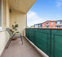 Balcony at a 2-room apartment on Veltlínska Street in Pezinok with a view of colorful buildings.