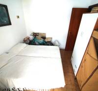 A room in a 3-room apartment with a bed, a bicycle, a wardrobe, and a picture on the wall.