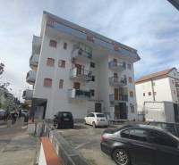 Apartment building in Scalea on 1 Maggio Street with surrounding cars and pedestrians.