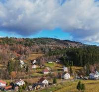 Turzovka offers residential plots with views of wooded hills and houses.