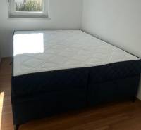 Bedroom in a 3-room apartment with a comfortable mattress and a floor with a wooden decor.