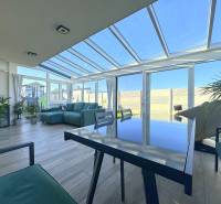 A bright room in a family house with a wooden decor floor and comfortable seating.