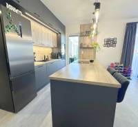 A kitchen in a family house with a wooden decor floor, bright and spacious.