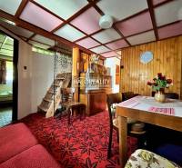 A stylish living area in a cabin with wooden decor and carpeted flooring.