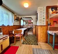 Interior of a cabin with wooden decor and a dining table.