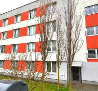 An apartment building with orange accents located on Podbrezovská Street in Bratislava - Rača.