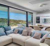 Spacious living room in a holiday apartment with a view, comfortable sofa, and kitchen.