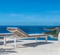 Sun loungers on the terrace of a holiday apartment in Rogoznica with a sea view.