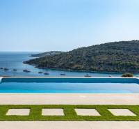A pool with a view of the sea and yachts in Rogoznica near a vacation apartment.
