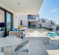 The Recreational Apartment in Rogoznica includes a terrace with a view of the pool and the sea.