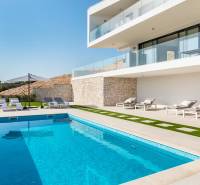 A recreational apartment in Rogoznica with a pool, sunbeds, and a terrace for relaxation.