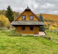 A wooden cottage in the middle of an autumn landscape on recreational grounds in Čereňany - Fančová.