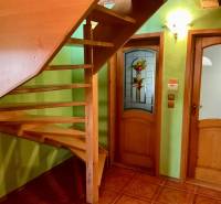 The staircase next to the stained glass door, the walls are light green, recreational grounds.