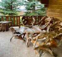 Wooden furniture on the porch overlooking the greenery in the recreational grounds in Čereňany - Fančová.