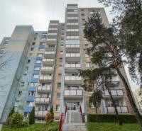 An apartment building in Bratislava, Dúbravka on Drobného Street, surrounded by trees and greenery.