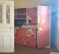 Colorful children's room in a family house with an unconventional wardrobe and carpet.