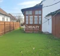 A family house in Rimavská Sobota with a spacious garden and a wooden fence.