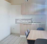 A kitchen in a family house with a simply furnished dining table and chairs.