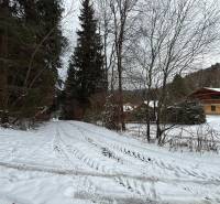 A snowy road leads through the Recreational lands in Čertov, Lazy pod Makytou, in the forest.