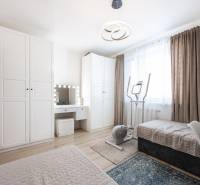 Bedroom in a 2-room apartment with a bed, wardrobes, and exercise equipment.