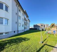 Apartment building on Železničná Street in Trenčianska Turná with a lawn and a children's playground.