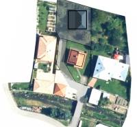 Aerial view of residential plots in the village of Dlhé Pole with surrounding development.