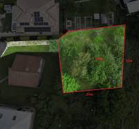 Aerial view of a residential plot in Dlhé Pole surrounded by greenery.