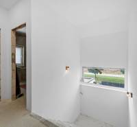 Interior renovation in a family house with white walls and a window to the exterior.