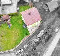 Aerial view of a family house in Kysucké Nové Mesto with a garden and a children's playground.