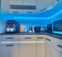 Kitchen in a 3-room apartment with lighting, appliances, and storage space.