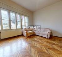 Living room in a 3-room apartment with a wooden decor floor and a sofa.