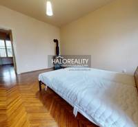 A bedroom in a 3-room apartment with a bed and a wooden decor floor.