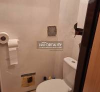 Bathroom with toilet in a 3-room apartment, white walls, toilet, tiled floor.
