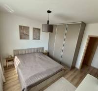 Bedroom in a 3-room apartment with a double bed and a wardrobe, floor with wood decor.